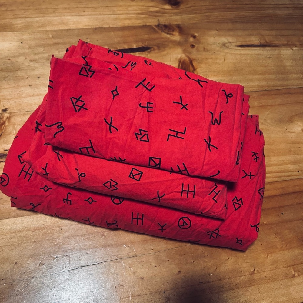 Vibrant Red Scarf with Black Symbols